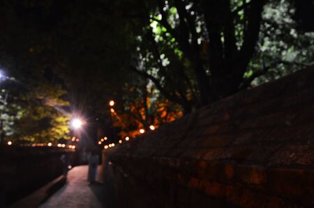 blurry of white suit Buddhism walking meditation on temple walkway in nightの写真素材
