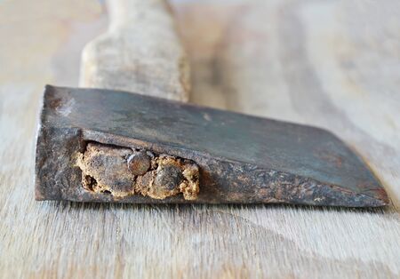 old iron ax with wooden handle on plankの写真素材