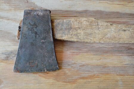 iron ax with wooden handle on plankの写真素材