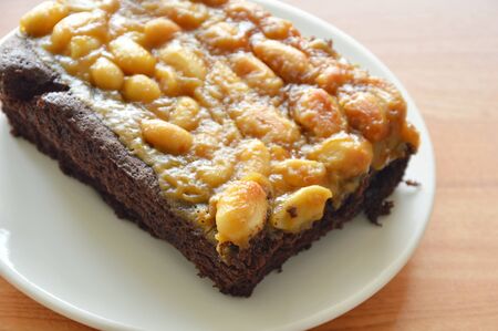 peanut butter caramel topping dark chocolate cake on plate