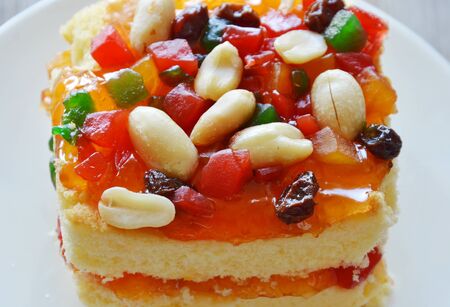 orange butter cake topping bean and dried fruit salad on dishの写真素材
