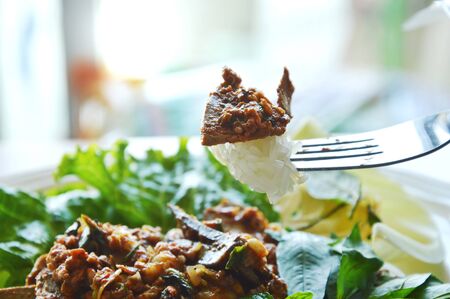 spicy pork liver salad with sticky rice stab in forkの写真素材