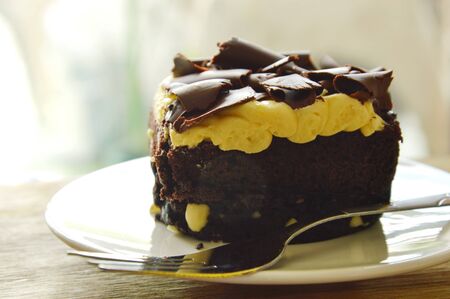 chocolate butter cake topping slicing chocolate and fork on dish