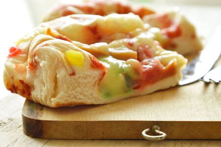 pork sausage bread with mayonnaise and butter on wooden chop blockの写真素材