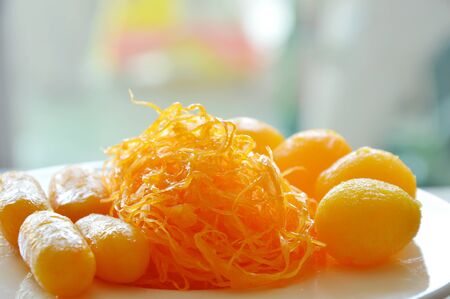 golden threads and bean paste with egg yolk fudge balls cooked in syrup assorted Thai sweetmeat on dishの写真素材