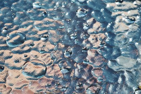 drop of water rolling on glass table after raining