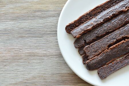 crispy dark chocolate stick bread on dishの写真素材