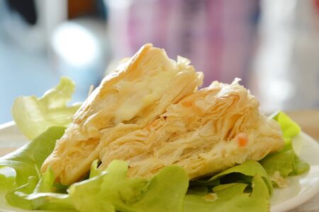 crispy chicken pie dressing cream sauce with green oak on dishの写真素材