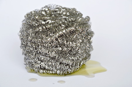 circle steel wool for heavy duty and dishwashing liquid on white backgroundの写真素材