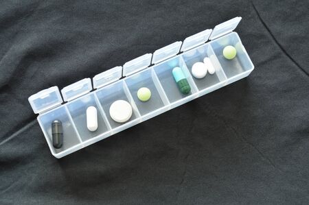 medicine and pill in plastic cartridges on black clothの写真素材