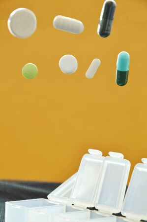 pill and capsule dropping to plastic boxの写真素材