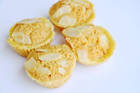 butter cookies cup topping slice almond on white backgroundの写真素材