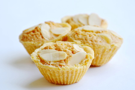butter cookies cup topping slice almond on white backgroundの写真素材
