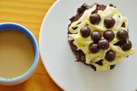 chocolate cake topping vanilla cream and ball with coffee