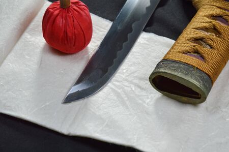 Japanese samurai sword blade and scabbard with red compress for cleaning