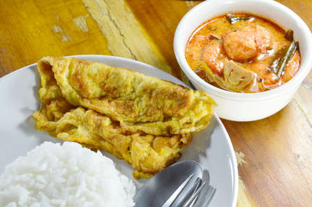 fried egg  on rice eat couple with spicy prawn Tom Yum soupの写真素材