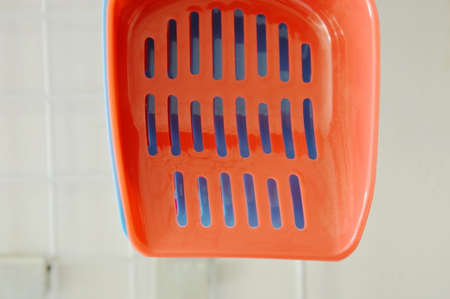 plastic cat litter shovel hanging on hook displays in pet shopの写真素材