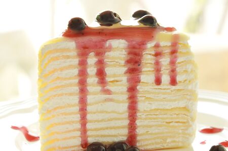 crape cake dressing blueberry sauce on plate