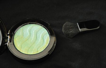 blusher powder cartridges and blush on black fabric backgroundの写真素材