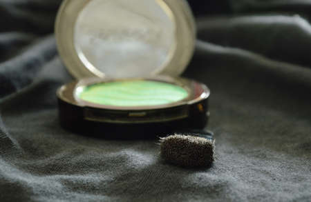 blusher powder cartridges and brush on black fabric backgroundの写真素材