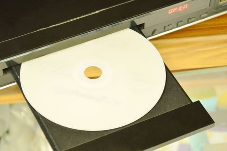 DVD put on insert disc player in wooden cupboardの写真素材