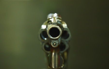 revolver gun muzzle ready to shoot on black background