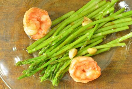 stir fried asparagus with prawn in oyster sauce on dishの写真素材