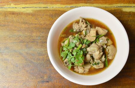 boiled chop chicken fish sauce soup topping parsley and spring onion on bowlの写真素材
