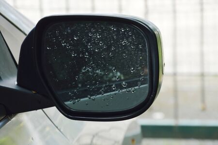 car wing mirror with lot water drop make poor visibility for driving
