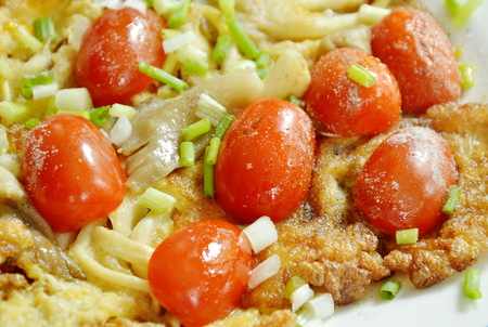 fried egg stuffed Indian mushroom topping slice cherry tomato on plateの写真素材