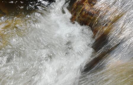 river flowing on cataract and water splashing