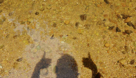human shadow lift hand and two thumb up in water