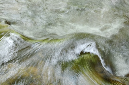 river flowing on cataract and water splashingの写真素材