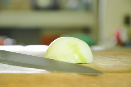 onion haft cut and knife prepare to cooking on wooden chop blockの写真素材