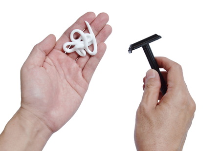 shaving cream on left hand and picking black shaver in rightの写真素材