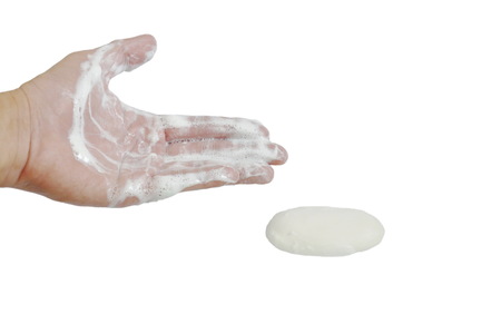 soapsuds on human hand and soap cube in white backgroundの写真素材