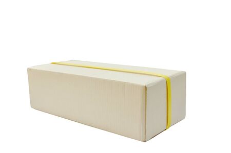 brown hard paper parcel wrapped by yellow plastic band on white backgroundの写真素材