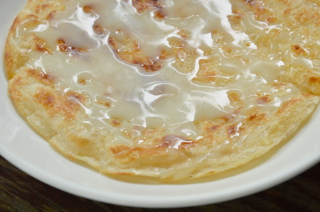 roti southern flat bread dressing sweet condensed milk on plateの写真素材