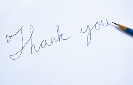 pencil write thank you word on white paperの写真素材
