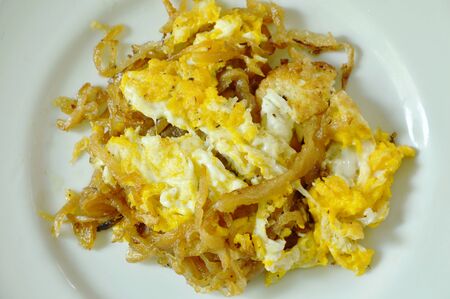 fried egg with sweet pickled radish on plateの写真素材