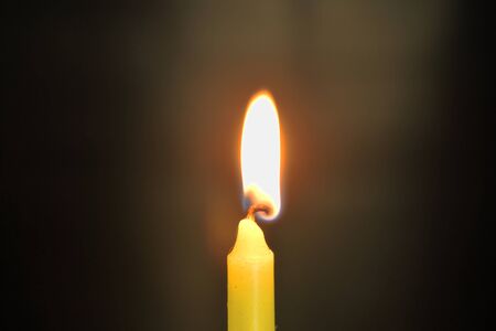 candle flame lighting in the dark nightの写真素材