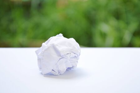 Crumpled white paper roll in garden backgroundの写真素材