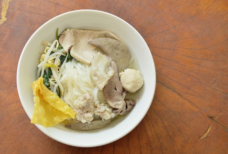 rice noodles topping pork ball and entrails in soup on bowlの写真素材