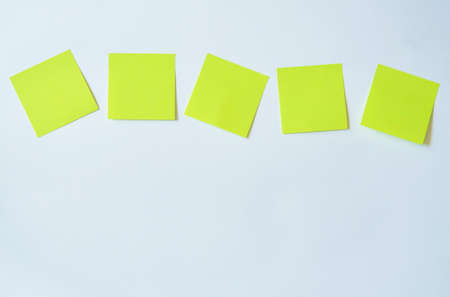 yellow paper note stick on white backgroundの写真素材