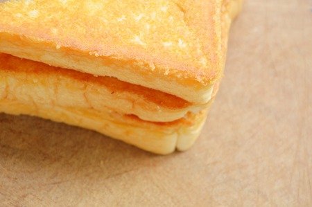 baked butter bread slice on wooden chopblock