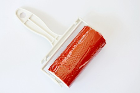 red sticky dust roller on white backgroundの写真素材