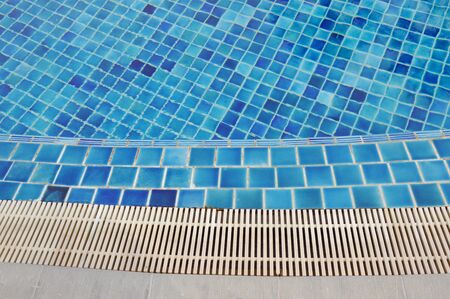 edge of blue tile swimming pool
