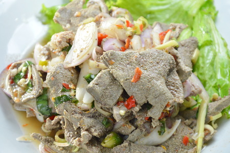 spicy slice boiled pork liver salad with herb on dishの写真素材