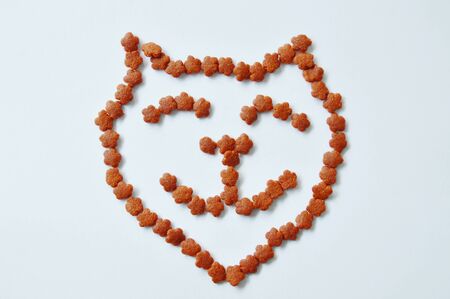 cat food arranging smiling face on white background