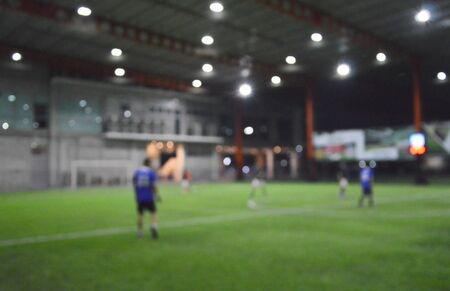 blurry of football player in stadium fieldの写真素材